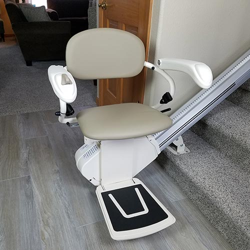 Harmar Pinnacle SL300 stairlift chair on a residential staircase with light flooring and a furnished interior